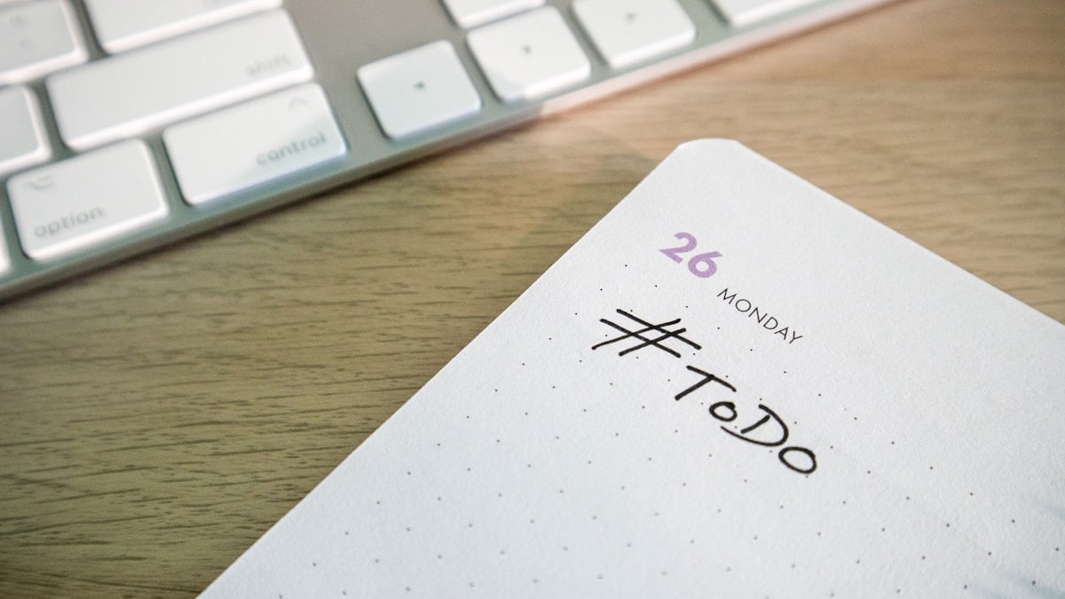 Desk with a keyboard and a planner with the hashtag #ToDo on it